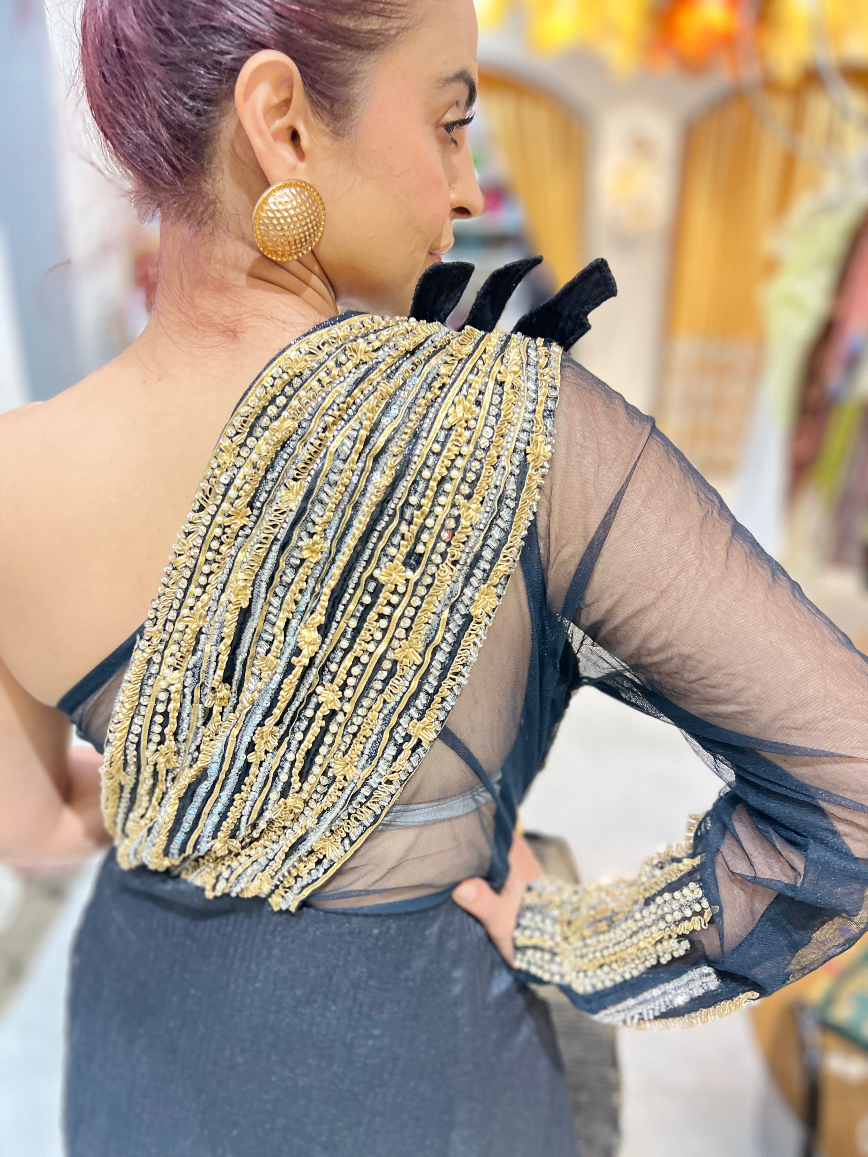 Off shoulder black embroidered gown with earrings